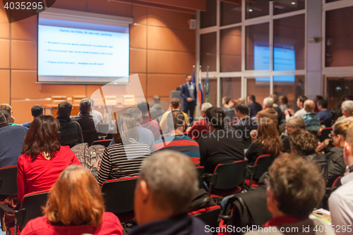 Image of Business speaker giving a talk in conference hall.