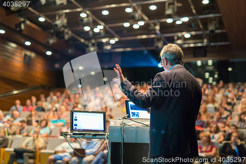 Image of Public speaker giving talk at Business Event.