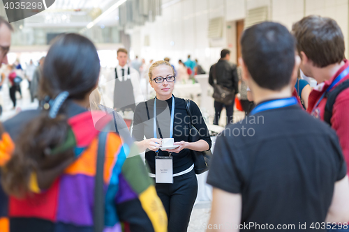 Image of People interacting during coffee break at medical conference.