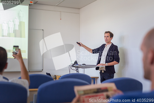 Image of Student presenting his study work in front of whiteboard.