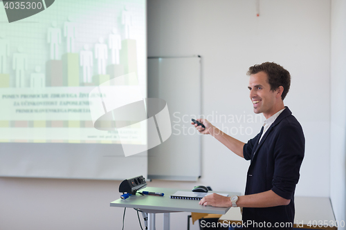 Image of Student presenting his study work in front of whiteboard.