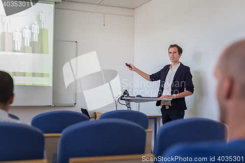 Image of Student presenting his study work in front of whiteboard.