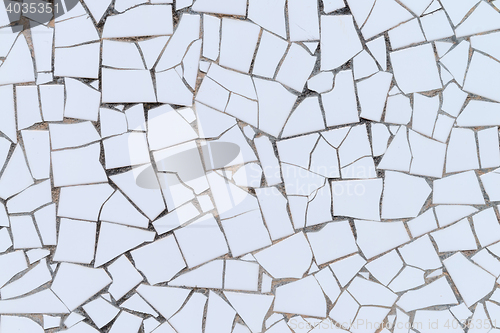 Image of White broken tiles wall