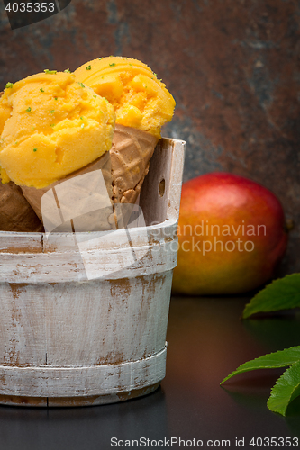 Image of Homemade mango ice cream in waffle cone