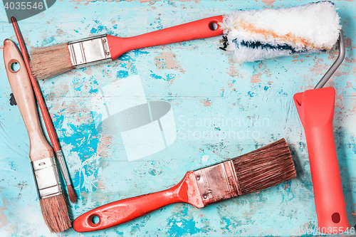 Image of Paint Brushes On A Blue Wooden Background