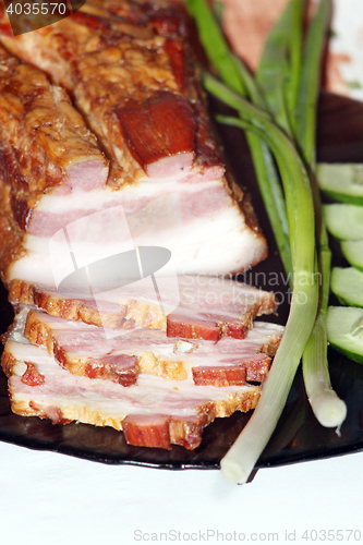 Image of pieces of fresh cooked meat with spring onions