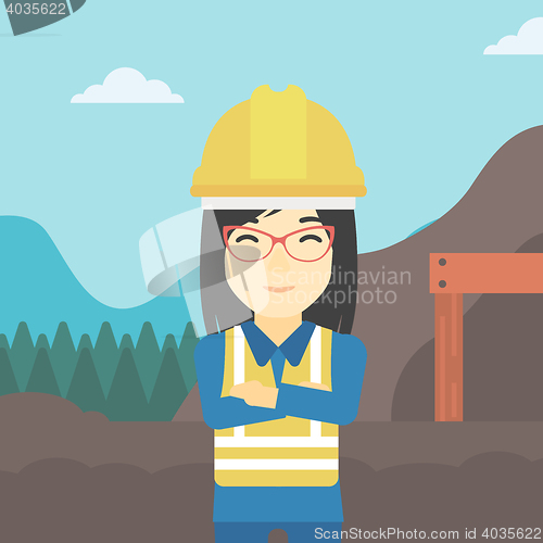 Image of Miner with mining equipment on background.