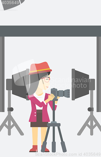 Image of Photographer working with camera on tripod.