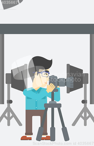 Image of Photographer working with camera on tripod.