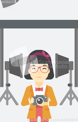 Image of Smiling photographer holding camera.