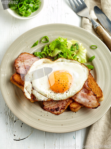 Image of fried egg, bacon and toasted bread