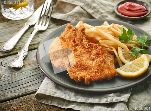 Image of pork schnitzel and fried potatoes