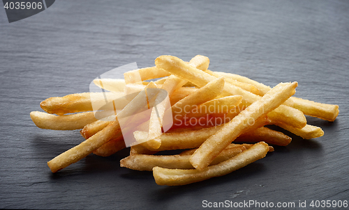 Image of french fries on black stone background