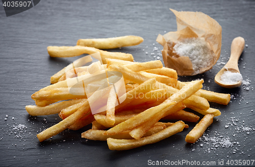 Image of french fries on black stone background