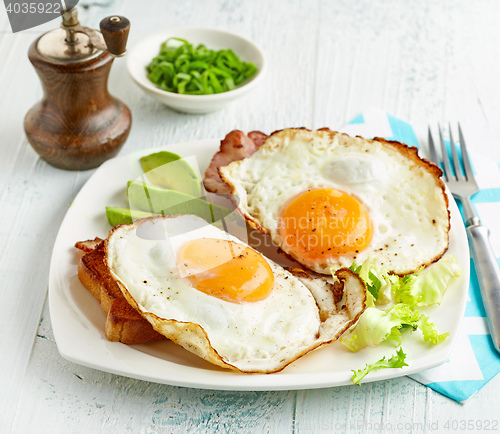 Image of fried eggs on white plate