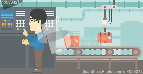 Image of Engineer standing near control panel.
