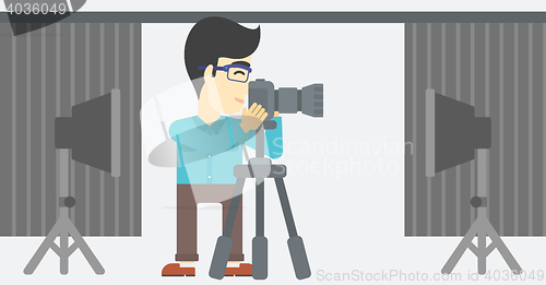 Image of Photographer working with camera on tripod.