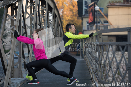 Image of couple warming up before jogging