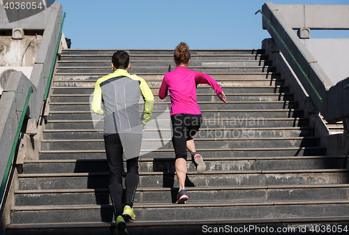 Image of young  couple jogging on steps