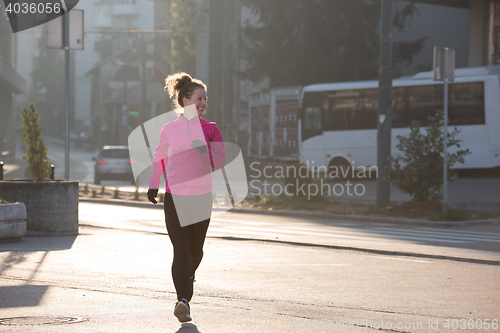 Image of sporty woman jogging on morning