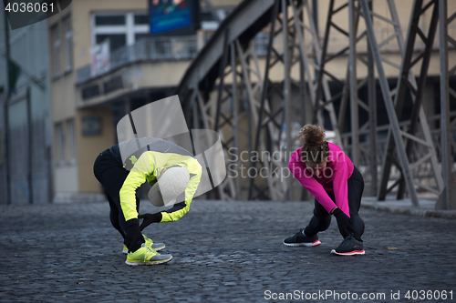 Image of couple warming up before jogging