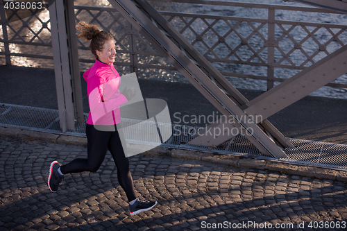 Image of sporty woman jogging on morning