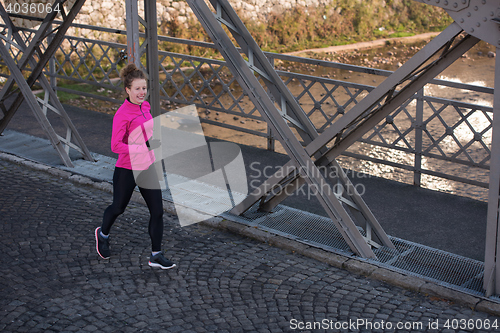 Image of sporty woman jogging on morning