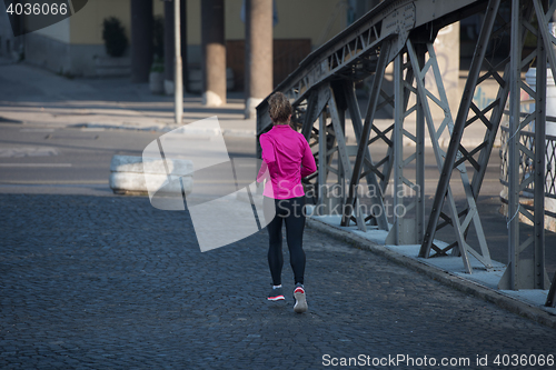 Image of sporty woman jogging on morning