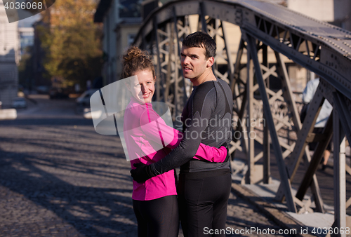 Image of couple warming up before jogging