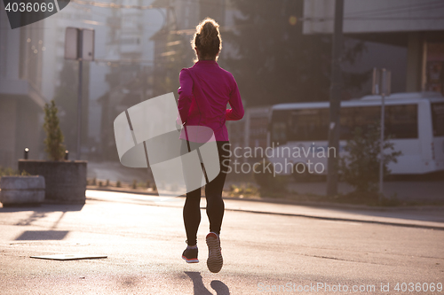 Image of sporty woman jogging on morning