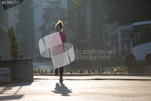 Image of sporty woman jogging on morning