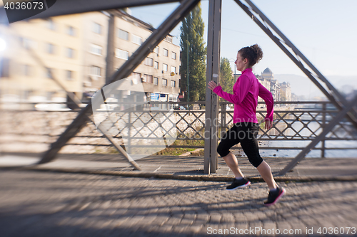 Image of sporty woman jogging on morning