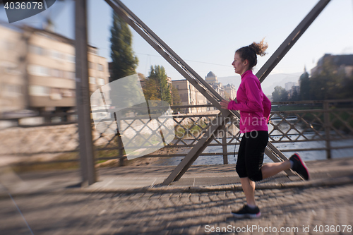 Image of sporty woman jogging on morning