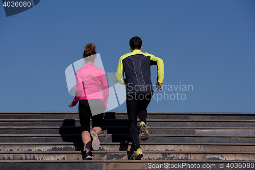 Image of young  couple jogging on steps