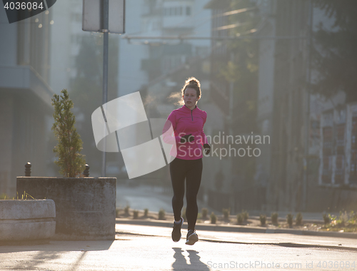 Image of sporty woman jogging on morning