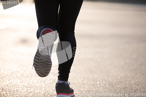 Image of sporty woman jogging on morning