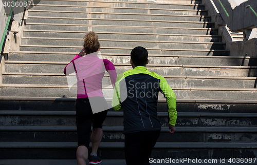 Image of young  couple jogging on steps