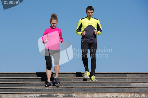 Image of young  couple jogging on steps