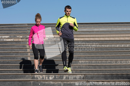 Image of young  couple jogging on steps
