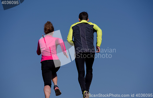 Image of young  couple jogging on steps