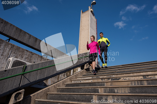 Image of young  couple jogging on steps