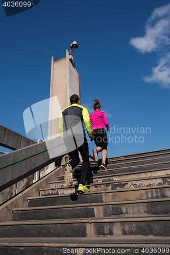 Image of young  couple jogging on steps