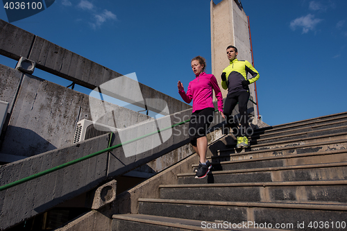 Image of young  couple jogging on steps