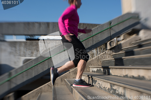 Image of woman jogging on  steps