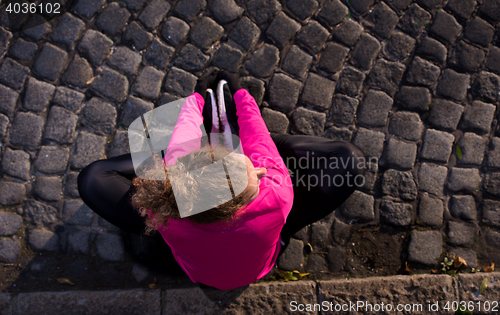 Image of woman  stretching before morning jogging