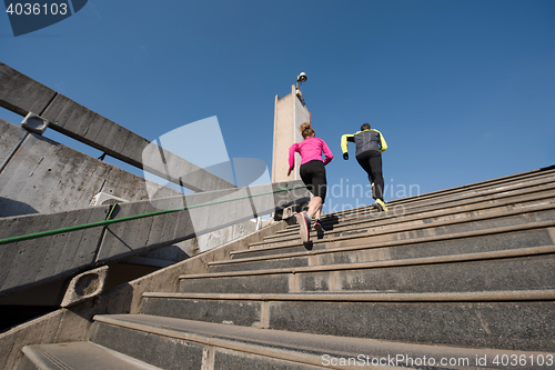 Image of young  couple jogging on steps