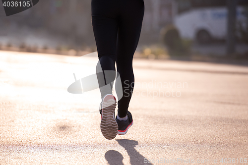 Image of sporty woman jogging on morning