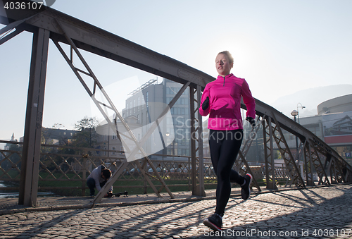 Image of sporty woman jogging on morning