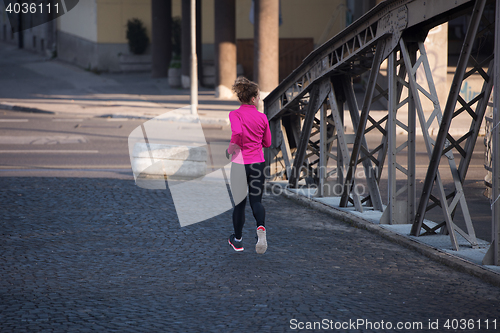 Image of sporty woman jogging on morning