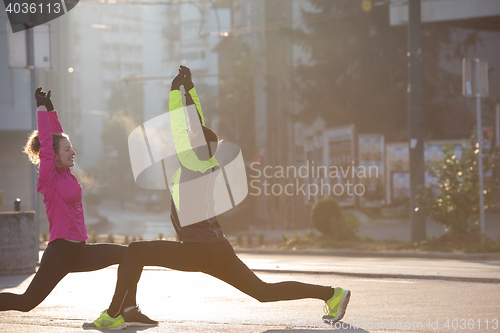 Image of couple warming up before jogging